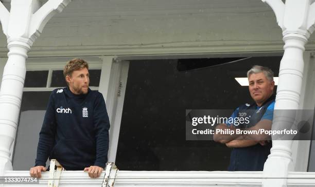 Joe Root and Chris Silverwood of England look out from the dressing room balcony on the fifth day of the 1st LV= Test match between England and India...