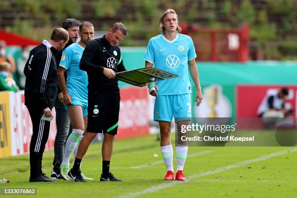 Head coach Mark van Bommel of Wolfsburg changes player Admir Mehmedi and Sebastiaan Bornauw during the DFB Cup first round match between Preußen...