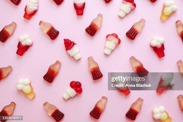 summer background made of fruit jelly gummy candies in shape of ice cream over pink background - キャンディ ストックフォトと画像