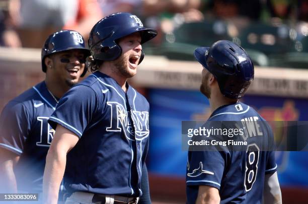 Brett Phillips of the Tampa Bay Rays celebrates with Brandon Lowe after hitting a grand slam in the eighth inning against the Baltimore Orioles at...
