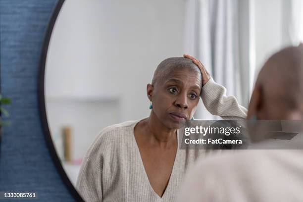 woman reckons with hair loss - hair loss stock pictures, royalty-free photos & images