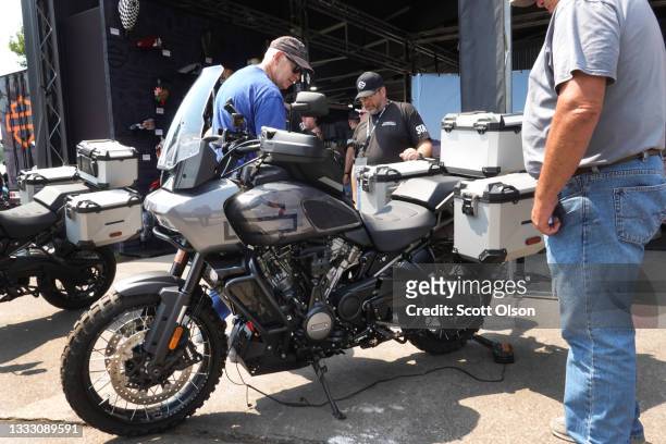 People look over Harley-Davidson's new adventure bike at their exhibit at the 81st annual Sturgis Motorcycle Rally on August 08, 2021 in Sturgis,...