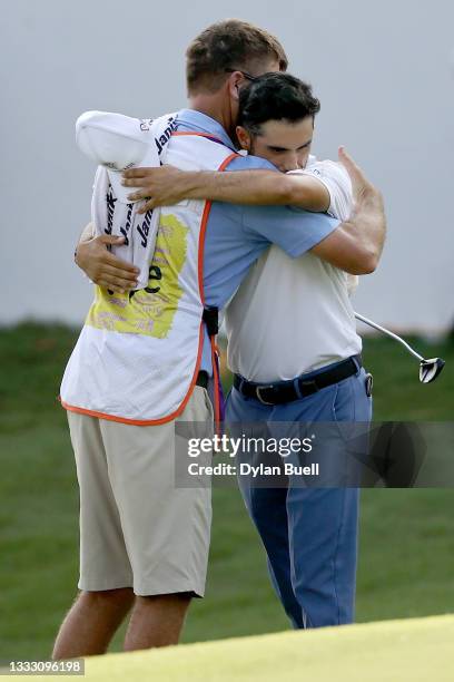 Abraham Ancer of Mexico and his caddie celebrate after winning the FedEx St. Jude Invitational after the second playoff hole at TPC Southwind on...