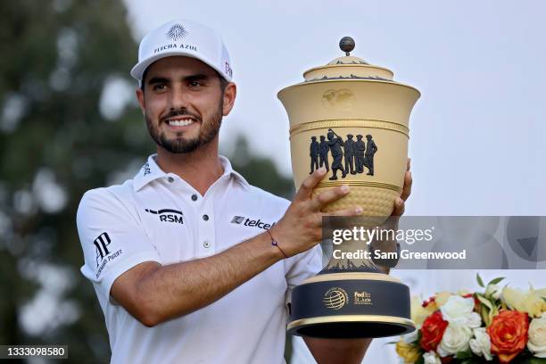 Abraham Ancer of Mexico poses with the trophy after winning the FedEx St. Jude Invitational after the second playoff hole at TPC Southwind on August...