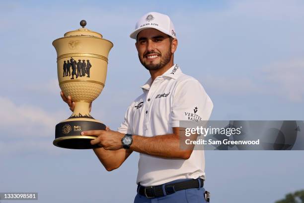 Abraham Ancer of Mexico poses with the trophy after winning the FedEx St. Jude Invitational after the second playoff hole at TPC Southwind on August...