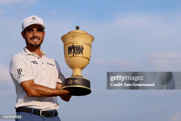 Abraham Ancer of Mexico poses with the trophy after winning the FedEx St. Jude Invitational after the second playoff hole at TPC Southwind on August...