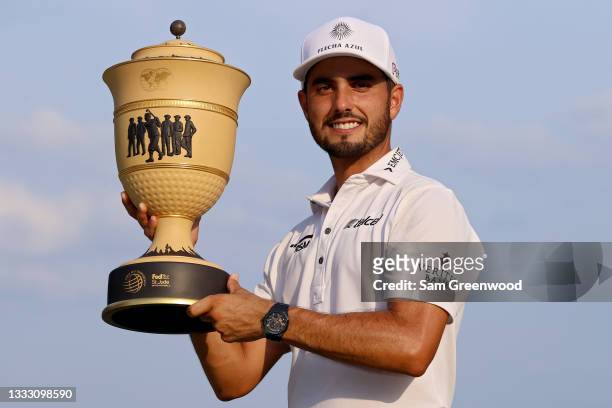 Abraham Ancer of Mexico poses with the trophy after winning the FedEx St. Jude Invitational after the second playoff hole at TPC Southwind on August...