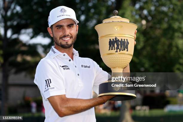 Abraham Ancer of Mexico poses with the trophy after winning the FedEx St. Jude Invitational after the second playoff hole at TPC Southwind on August...