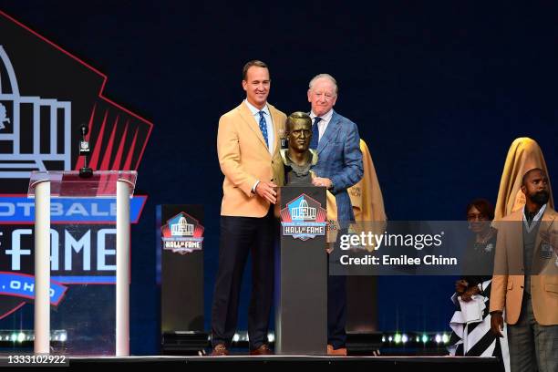 Peyton Manning and his father Archie Manning pose after unveiling his bust during the NFL Hall of Fame Enshrinement Ceremony at Tom Benson Hall Of...