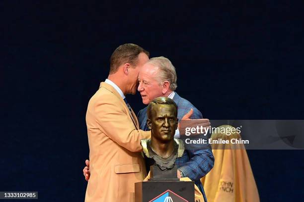 Peyton Manning shares a moment with his father Archie Manning after unveiling his bust during the NFL Hall of Fame Enshrinement Ceremony at Tom...