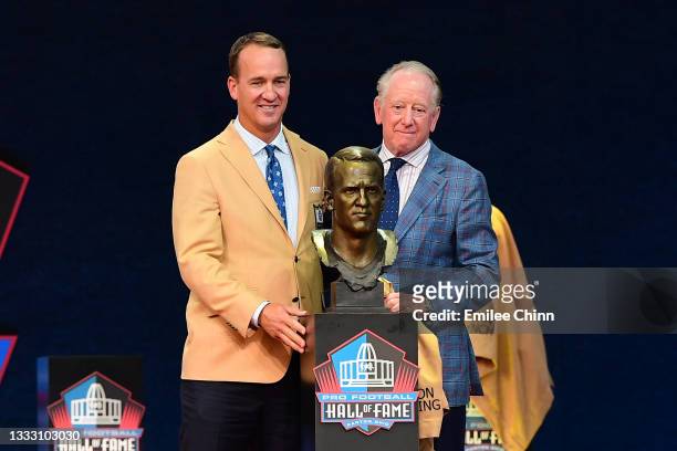 Peyton Manning and his father Archie Manning pose after unveiling his bust during the NFL Hall of Fame Enshrinement Ceremony at Tom Benson Hall Of...