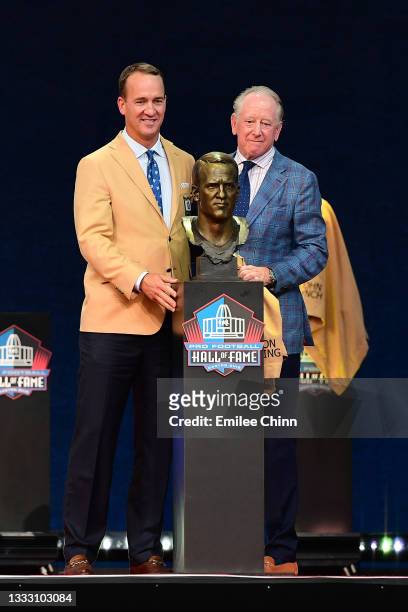 Peyton Manning and his father Archie Manning pose after unveiling his bust during the NFL Hall of Fame Enshrinement Ceremony at Tom Benson Hall Of...