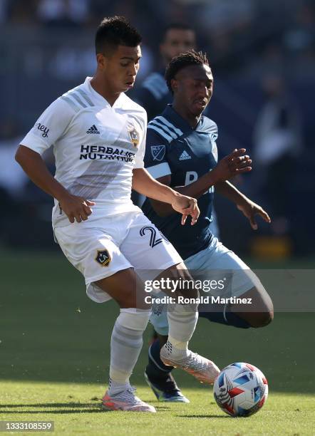 Efrain Alvarez of Los Angeles FC controls the ball against Janio Bikel of Vancouver Whitecaps in the first half at Dignity Health Sports Park on...