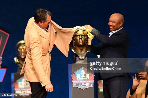 Alan Faneca unveils his bust with Hines Ward during the NFL Hall of Fame Enshrinement Ceremony at Tom Benson Hall Of Fame Stadium on August 08, 2021...