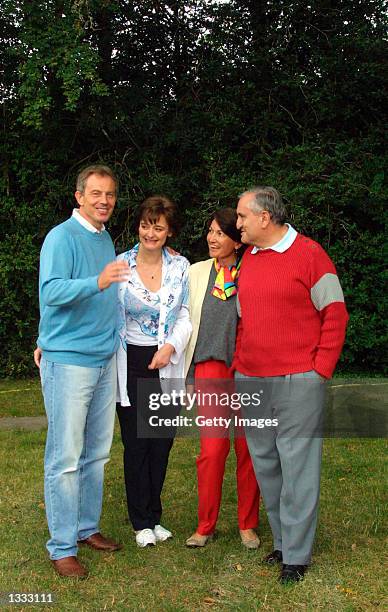 British Prime Minister Tony Blair and his French counterpart Jean-Pierre Raffarin are shown with wives Anne-Marie Raffarin and Cherie Blair at La...