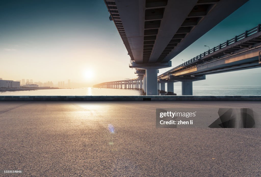 Asphalt road under the viaduct