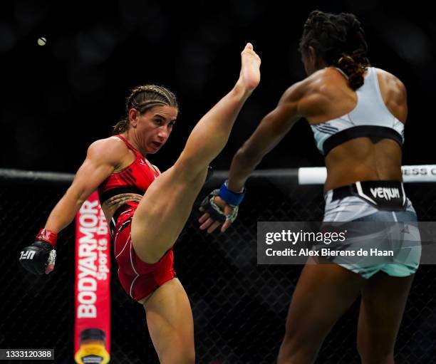 Tecia Torres kicks in front of Angela Hill during their Strawweight fight at Toyota Center on July 7, 2021 in Houston, Texas.