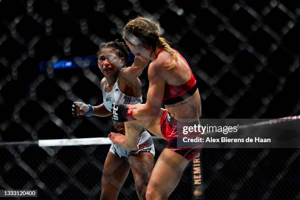 Angela Hill punches Tecia Torres during their Strawweight fight at Toyota Center on July 7, 2021 in Houston, Texas.