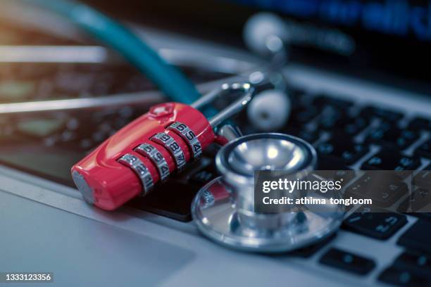 stethoscope and padlock on a computer keyboard. - data breach stock pictures, royalty-free photos & images