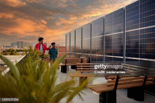 commercial real estate agent showing clients solar panels - environmental building stock pictures, royalty-free photos & images