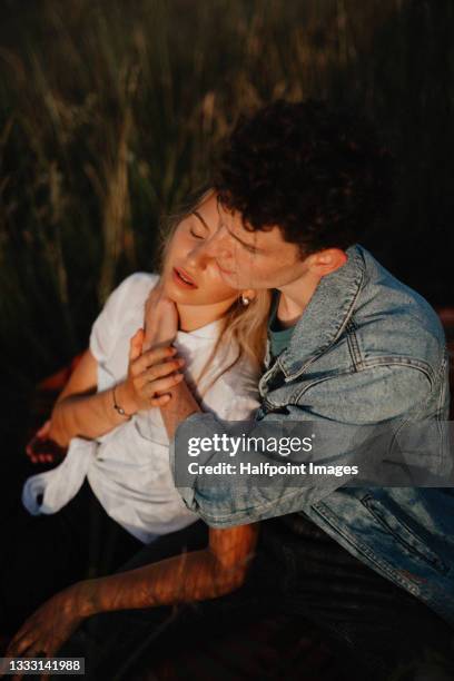 top view of young couple on a walk outdoors in nature, resting on blanket. - young couple enjoying a walk through grassland stock pictures, royalty-free photos & images