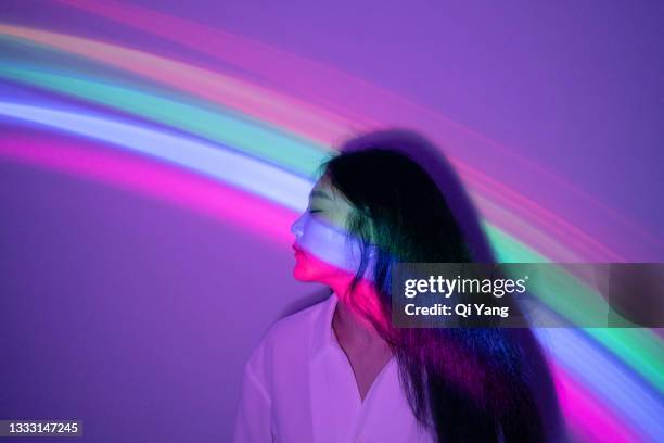 young asian woman on rainbow background - feminism stock pictures, royalty-free photos & images