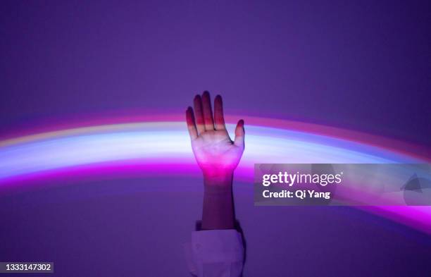 touching the rainbow - púrpura fotografías e imágenes de stock