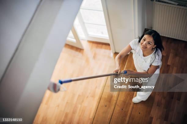 asian woman painting ceiling at home - painting ceiling stock pictures, royalty-free photos & images