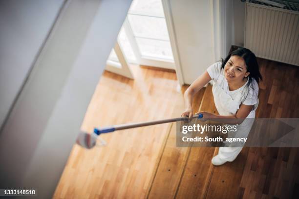 asian woman painting ceiling at home - painted ceiling stock pictures, royalty-free photos & images