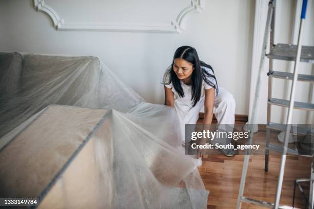 woman preparing for painting walls - drop cloth stock pictures, royalty-free photos & images