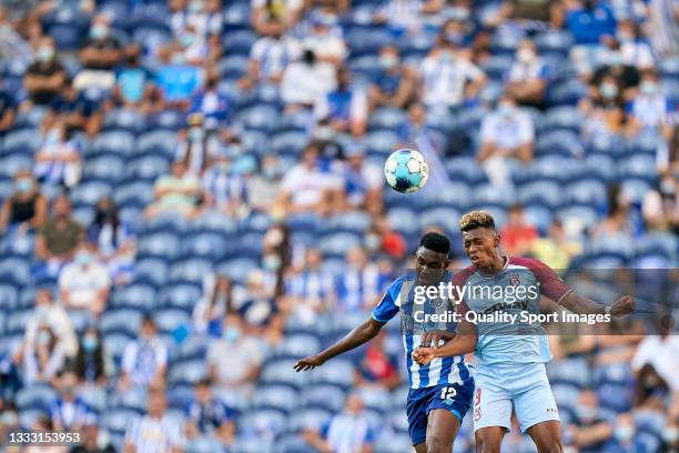 Zaidu Sanusi of FC Porto competes for the ball with Mateo Cassierra of Belenenses SAD during the Liga Portugal Bwin match between FC Porto and...
