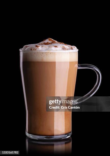 glass of cappuccino on black background - cris cantón photography stock-fotos und bilder