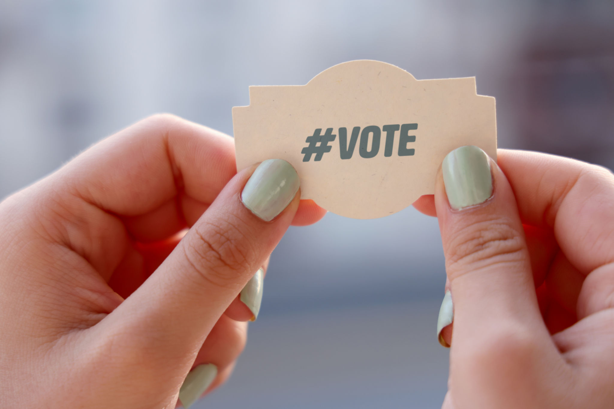 Woman holding vote note Woman holding vote note