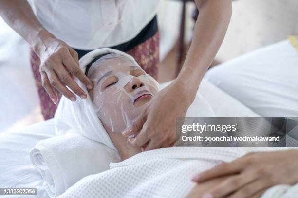 woman in mask on face in spa beauty salon - spa treatment ストックフォトと画像