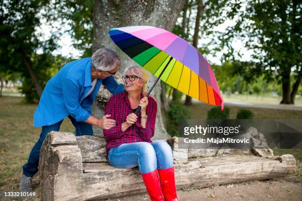 couple walking in wet day - sharing umbrella stock pictures, royalty-free photos & images