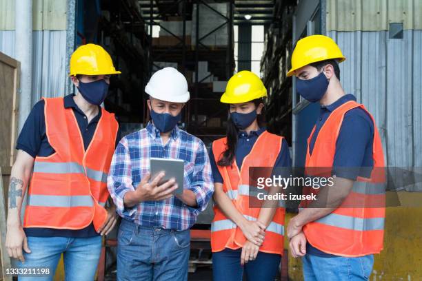 warehouse workers talking with boss - employee safety stock pictures, royalty-free photos & images