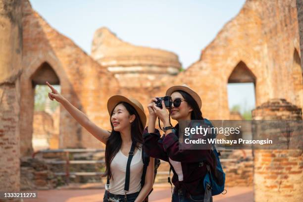a beautiful tourist is having fun at an old temple in ayutthaya in thailand. - ayuthaya stock pictures, royalty-free photos & images