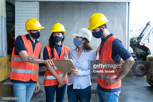 warehouse workers talking with manager - businesswoman mask stock pictures, royalty-free photos & images