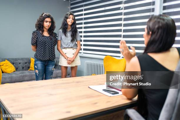 elementary age girls talks to school counselor - student in principal office stock pictures, royalty-free photos & images