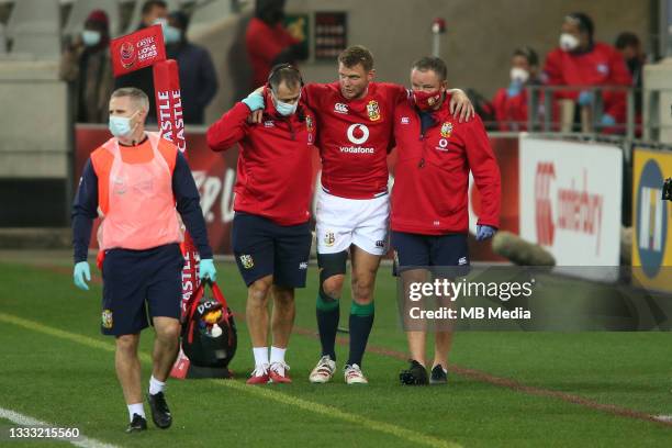 Dan Biggar of the British & Irish Lions is helped from the field with a leg injury during the 3rd Test between South Africa and the British & Irish...