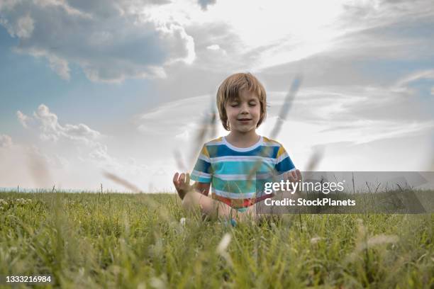 cute child with eyes closed  practices yoga - only boys stock pictures, royalty-free photos & images