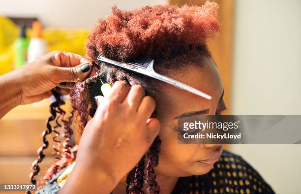 woman getting her hair done during an appointment in a beauty salon - hårförlängning bildbanksfoton och bilder