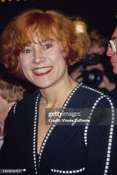 American-Canadian actress Jennifer Tilly, wearing a navy blue jacket with white embellishment, attends the Westwood premiere of 'The Pelican Brief'...