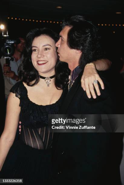 American-Canadian actress Jennifer Tilly, wearing a black dress, with American actor Lou Diamond Phillips, wearing a black jacket, attend the...