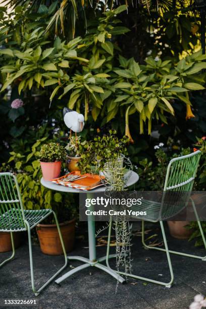 green garden furniture in a small garden. - small garden stock pictures, royalty-free photos & images