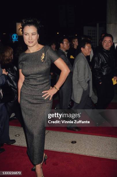 American-Canadian actress Jennifer Tilly, wearing a grey full-length dress with a bateau neckline, attends a screening of the 15th-anniversary...