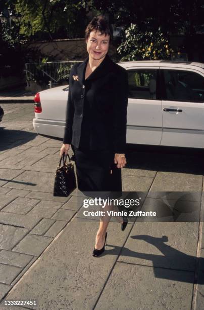 American-Canadian actress Jennifer Tilly, wearing a black jacket with a black skirt, and holding a black handbag, attends Premiere Magazine's 3rd...