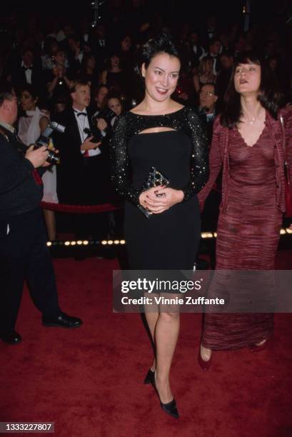 American-Canadian actress Jennifer Tilly, wearing a black dress with a black sequin shrug, and her sister, American-Canadian actress Meg Tilly,...