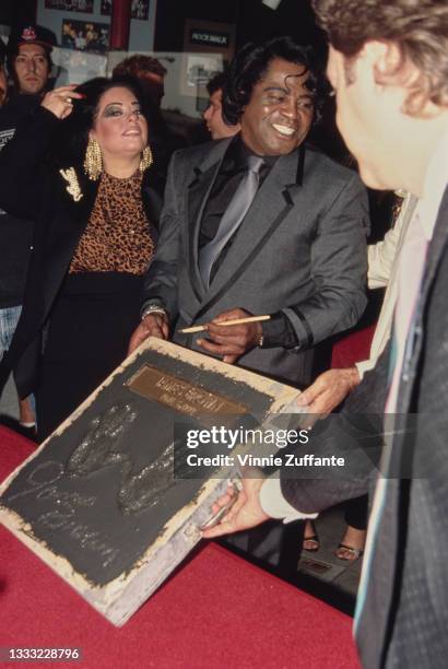 Adrienne Rodriguez and American singer, songwriter and musician James Brown during his ceremony at Hollywood's RockWalk on Vine Street in Los...