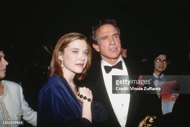 American actress Annette Bening and American actor Warren Beatty attend the 49th Annual Golden Globe Awards, held at the Beverly Hilton Hotel in...